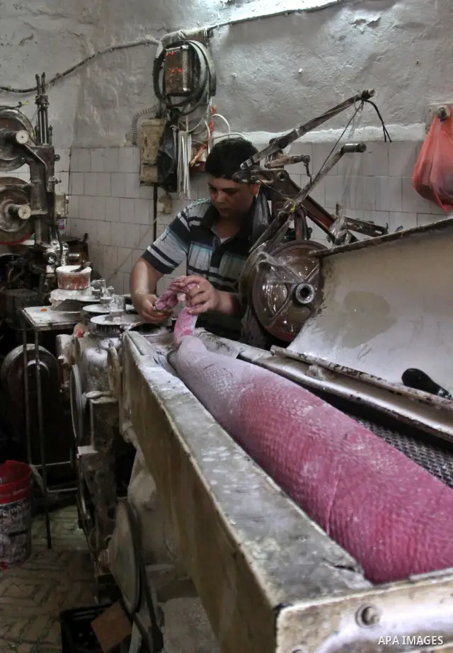 Palestinian labourers work at a factory for making a kind of candy " Toffee" in the West Bank city of Nablus on July 26, 2012. Photo by Nedal Eshtayah