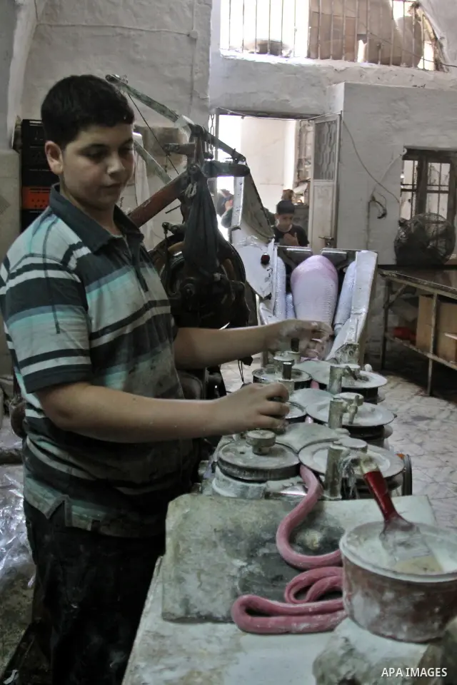 Palestinian labourers work at a factory for making a kind of candy " Toffee" in the West Bank city of Nablus on July 26, 2012. Photo by Nedal Eshtayah