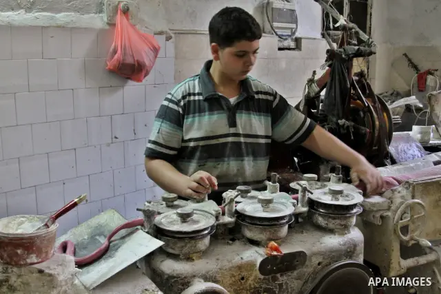 Palestinian labourers work at a factory for making a kind of candy " Toffee" in the West Bank city of Nablus on July 26, 2012. Photo by Nedal Eshtayah