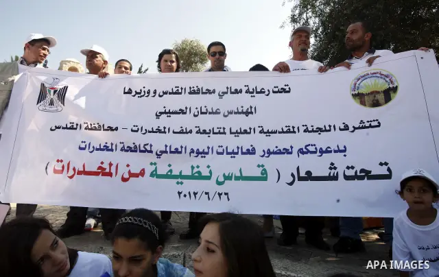 Palestinians hold banners with slogans against drug during a rally as part of events of an International Day Against Drug in Jerusalem's Old City on June 26, 2012. Photo by Mahfouz Abu Turk