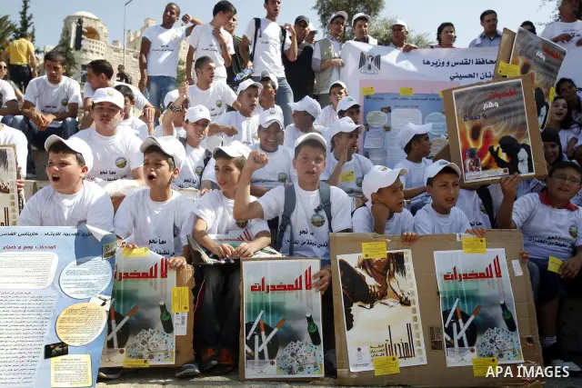 Palestinian children hold banners with slogans against drug during a rally as part of events of an International Day Against Drug in Jerusalem's Old City on June 26, 2012. Photo by Mahfouz Abu Turk