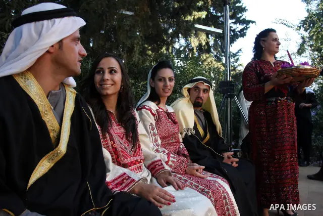 Palestinians wear Heritage fashions as they take part in a Palestinian wedding, during the opening of the "Heritage Week V in Birzeit 2012" in the old town of Birzeit in Ramallah, West Bank, 27 June 2012. Photo by Issam...