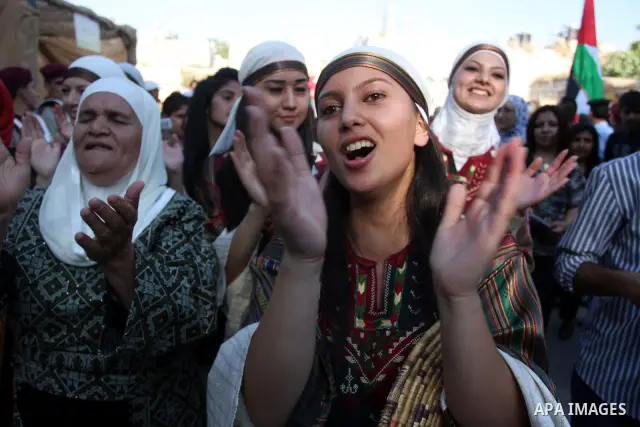 Palestinians sing folk songs as they take part in a Palestinian wedding, during the opening of the "Heritage Week V in Birzeit 2012" in the old town of Birzeit in Ramallah, West Bank, 27 June 2012. Photo by Issam Rimawi