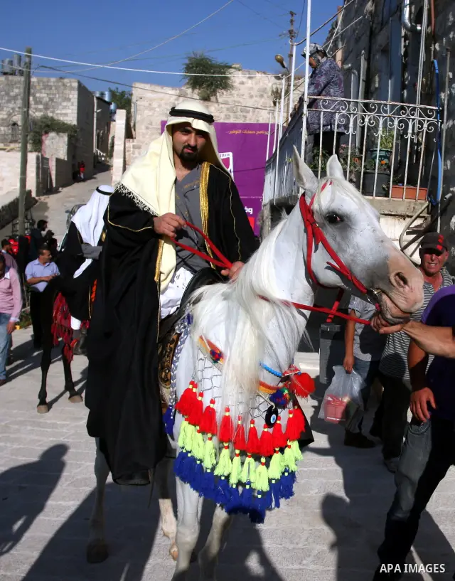 A Palestinian groom ride a horse during his traditional wedding in the opening of the "Heritage Week V in Birzeit 2012" in the old town of Birzeit in Ramallah, West Bank, 27 June 2012. Photo by Issam Rimawi