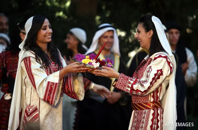 Palestinian brides perform folk dancing as they take part in a Palestinian wedding, during the opening of the "Heritage Week V in Birzeit 2012" in the old town of Birzeit in Ramallah, West Bank, 27 June 2012. Photo by Is...