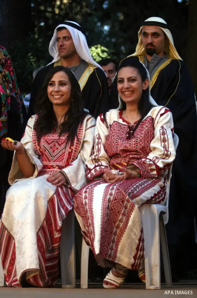 Palestinian grooms and brides take a picture during a Palestinian wedding, in the opening of the "Heritage Week V in Birzeit 2012" in the old town of Birzeit in Ramallah, West Bank, 27 June 2012. Photo by Issam Rimawi
