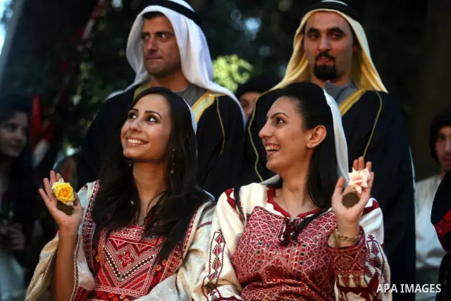 Palestinian brides show Henna patterns on their hands as they take part in a Palestinian wedding, during the opening of the "Heritage Week V in Birzeit 2012" in the old town of Birzeit in Ramallah, West Bank, 27 June 201...