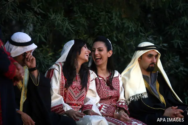 Palestinians wear Heritage fashions as they take part in a Palestinian wedding, during the opening of the "Heritage Week V in Birzeit 2012" in the old town of Birzeit in Ramallah, West Bank, 27 June 2012. Photo by Issam...