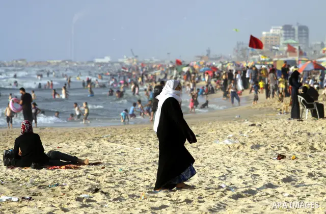 Palestinians enjoy swimming in the sea on Gaza's beach on 27 June 2012 in Gaza City . Photo by Majdi Fathi