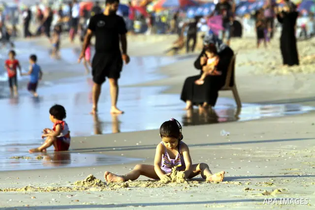 Palestinians enjoy swimming in the sea on Gaza's beach on 27 June 2012 in Gaza City . Photo by Majdi Fathi