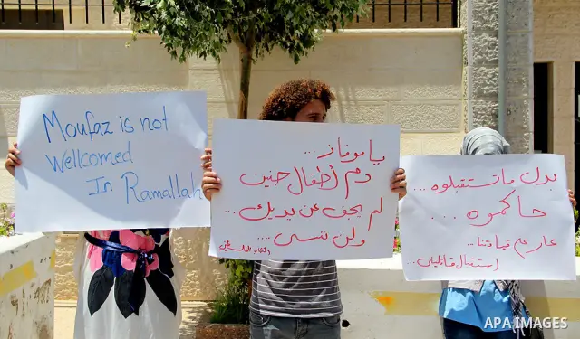 Palestinian protestors hold signs bearing slogans against the upcoming visit of Israeli vice prime minister Shaul Mofaz to the West Bank city of Ramallah for a meeting with Palestinian president Mahmud Abbas, outside the...