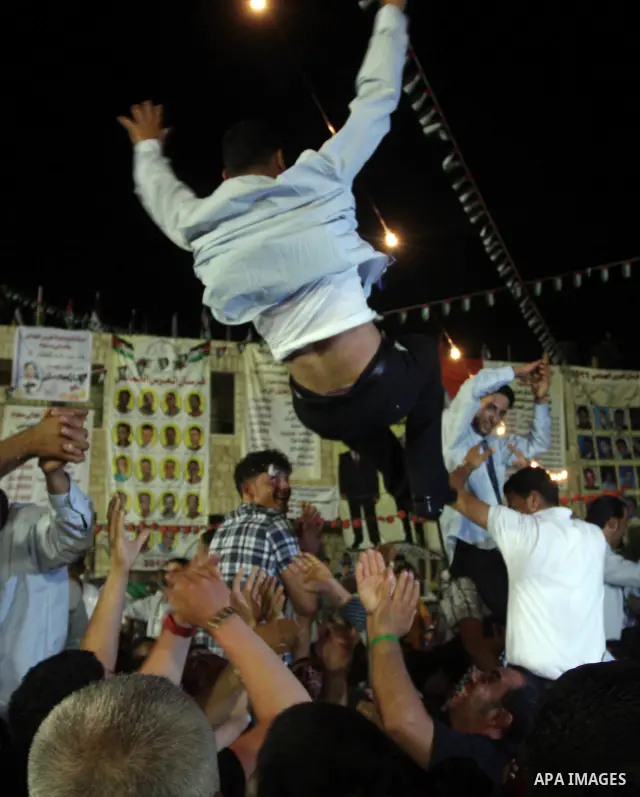 Palestinians celebrate during a mass wedding for 19 Groom, participation of Palestinian President Mahmoud Abbas (not seen) in the village of Silwad in the West Bank city of Ramallah, June 28, 2012. Photo by Issam Rimawi
