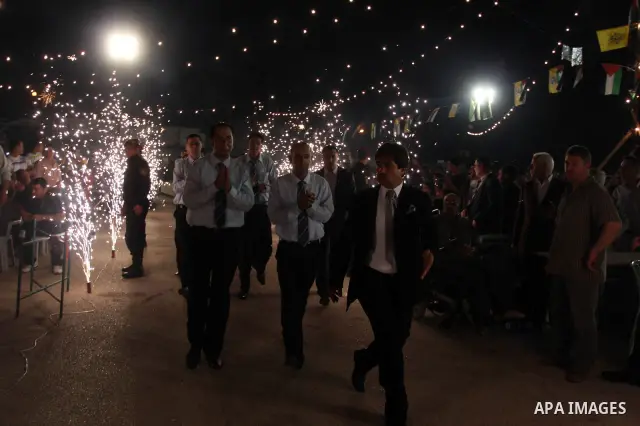 Palestinians celebrate during a mass wedding for 19 Groom, participation of Palestinian President Mahmoud Abbas (not seen) in the village of Silwad in the West Bank city of Ramallah, June 28, 2012. Photo by Issam Rimawi