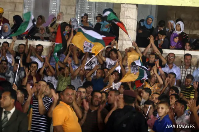 Palestinians celebrate during a mass wedding for 19 Groom, participation of Palestinian President Mahmoud Abbas (not seen) in the village of Silwad in the West Bank city of Ramallah, June 28, 2012. Photo by Issam Rimawi