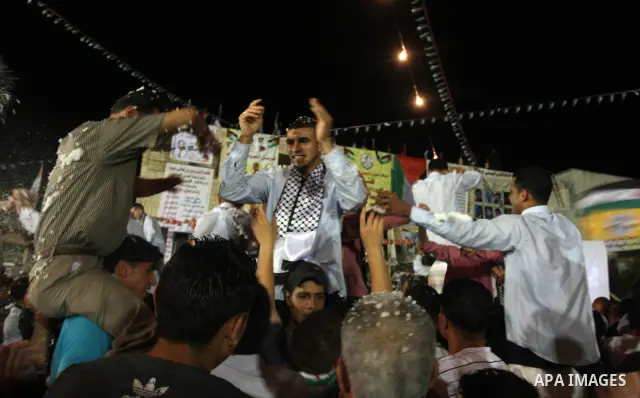 Palestinians celebrate during a mass wedding for 19 Groom, participation of Palestinian President Mahmoud Abbas (not seen) in the village of Silwad in the West Bank city of Ramallah, June 28, 2012. Photo by Issam Rimawi