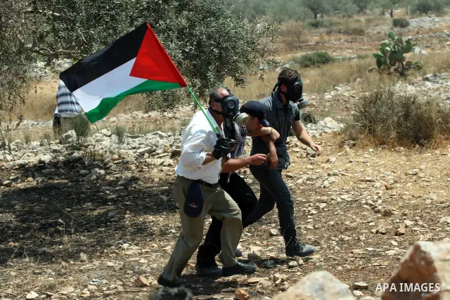 Palestinian protestors help a wounded man during clashes with Israeli troops following a weekly protest against the Jewish settlement of Kdumim, near Nablus,in the northern West Bank village of Kufr Qaddum, June 29, 2012...