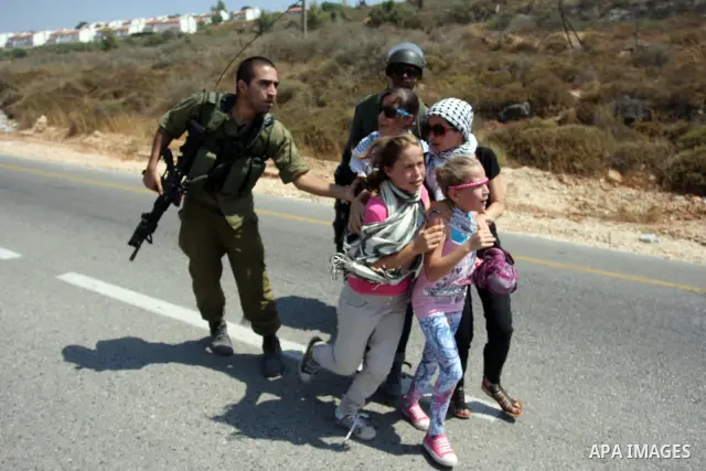 Israeli soldiers confront Palestinian protesters during a demonstration against Israel's separation barrier in the West Bank village of Nabi Saleh near Ramallah, Friday, June 29, 2012. Palestinians protest weekly against...
