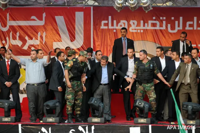 Egypt's president-elect Mohamed Morsi asks security guards to clear the way between him and gathering protesters at the end of this speech in Tahrir square, Cairo, Egypt, 29 June 2012. Media reports stated Morsi said on...