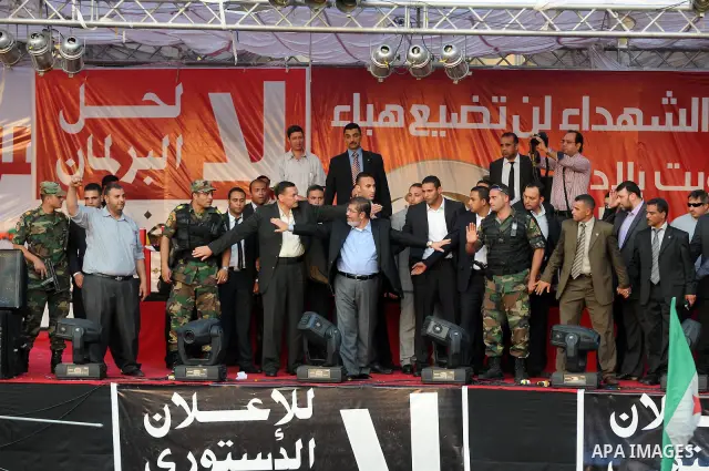 Egypt's president-elect Mohamed Morsi asks security guards to clear the way between him and gathering protesters at the end of this speech in Tahrir square, Cairo, Egypt, 29 June 2012. Media reports stated Morsi said on...
