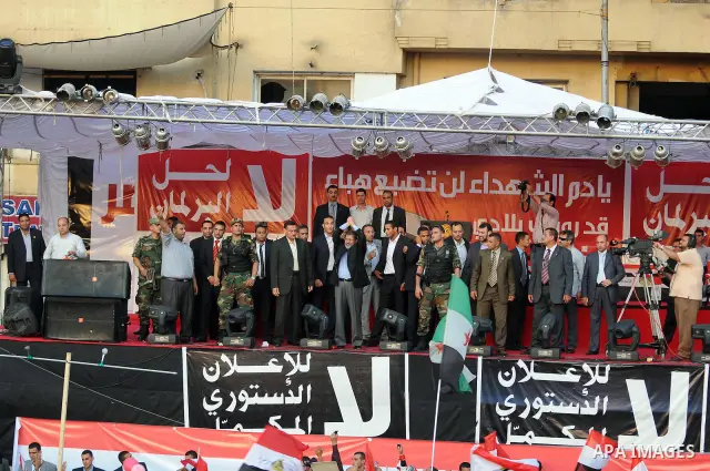 Egypt's president-elect Mohamed Morsi, surrounded by security guards, waves to protesters at the end of his speech at Tahrir square, in Cairo, Egypt, 29 June 2012. Media reports stated Morsi said on 29 June that people p...