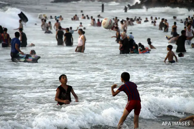 Palestinians enjoy swimming on their week-end in the Mediterranean sea in Gaza City on June 29, 2012. Photo by Majdi Fathi