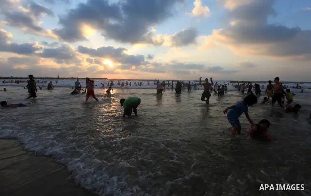 Palestinians enjoy swimming on their week-end in the Mediterranean sea in Gaza City on June 29, 2012. Photo by Majdi Fathi