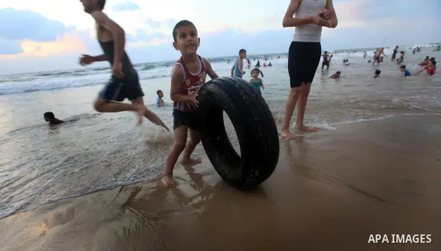 Palestinians enjoy swimming on their week-end in the Mediterranean sea in Gaza City on June 29, 2012. Photo by Majdi Fathi