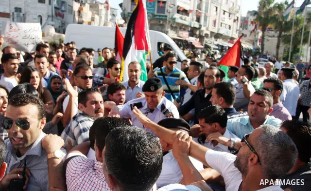 Palestinians shout slogans during a protest against a meeting between Palestinian President Mahmoud Abbas and Israeli Vice Prime Minister Shaul Mofazin, in the West Bank city of Ramallah, Saturday, June 30, 2012. A sched...