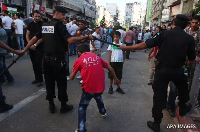 Palestinian police control the crowd in the West Bank city of Ramallah, on June 30, 2012, during a protest against a planned meeting between Palestinian leader Mahmud Abbas and Israel's vice prime minister Shaul Mofaz. T...