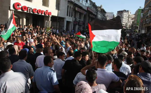 Palestinian police control the crowd in the West Bank city of Ramallah, on June 30, 2012, during a protest against a planned meeting between Palestinian leader Mahmud Abbas and Israel's vice prime minister Shaul Mofaz. T...