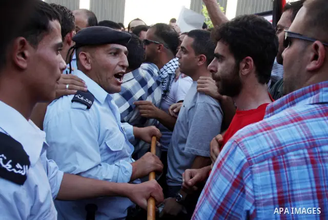 Palestinian police control the crowd in the West Bank city of Ramallah, on June 30, 2012, during a protest against a planned meeting between Palestinian leader Mahmud Abbas and Israel's vice prime minister Shaul Mofaz. T...