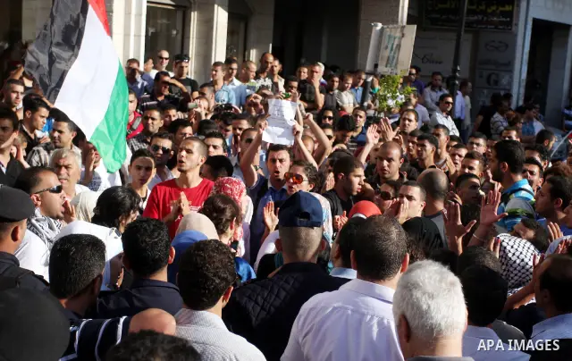 Palestinian police control the crowd in the West Bank city of Ramallah, on June 30, 2012, during a protest against a planned meeting between Palestinian leader Mahmud Abbas and Israel's vice prime minister Shaul Mofaz. T...