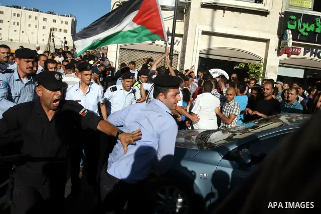Palestinian Policemen block protesters from reaching the Palestinian presidential headquarters in the West Bank city of Ramallah, during a protest in the town, on 01 July 2012. Demonstrators protested against a scheduled...