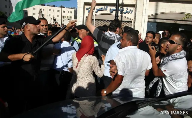 Palestinian Policemen block protesters from reaching the Palestinian presidential headquarters in the West Bank city of Ramallah, during a protest in the town, on 01 July 2012. Demonstrators protested against a scheduled...
