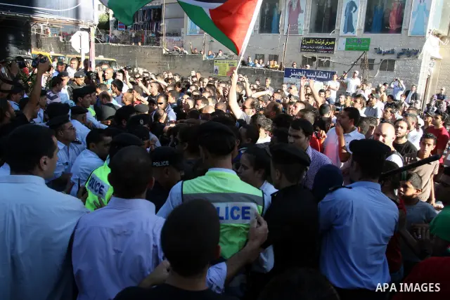 Palestinian Policemen block protesters from reaching the Palestinian presidential headquarters in the West Bank city of Ramallah, during a protest in the town, on 01 July 2012. Demonstrators protested against a scheduled...