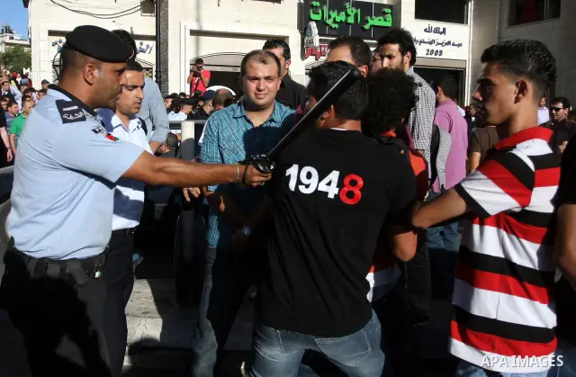 Palestinian Policemen block protesters from reaching the Palestinian presidential headquarters in the West Bank city of Ramallah, during a protest in the town, on 01 July 2012. Demonstrators protested against a scheduled...