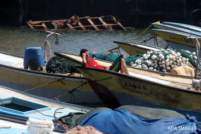 A Palestinian boy sits in a boat in front of Gaza port on July 02, 2012.The European Union's envoy to the Palestinian Authority confirmed its support and allegiance to the people. Photo by Majdi Fathi
