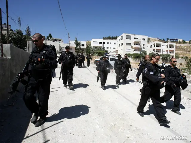 Israeli forces guard a destruction process of a Palestinian owned shop that was built without a permit in the neighbourhood of Issawiya, in the north of Jerusalem, on July 02, 2012. Israel revoked the residency of nearly...