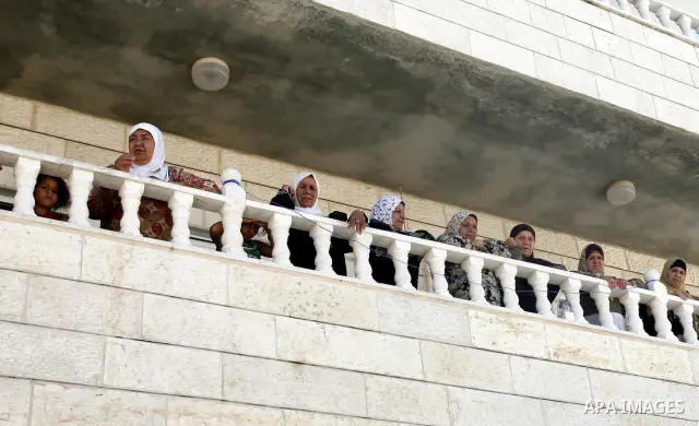 Palestinian women look at a shop destroyed by Israeli forces on the pretext of building without a permit in the neighbourhood of Issawiya, in the north of Jerusalem, on July 02, 2012. Israel revoked the residency of near...