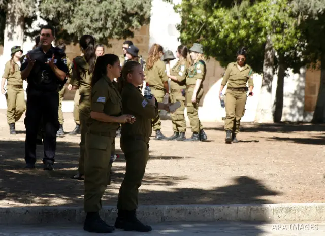 Israeli soldiers walk past the Al-Aqsa mosque compound, Islam's third holiest site, during a visit under Israeli police protection in Jerusalem's Old City on July 02, 2012. Photo by Mahfouz Abu Turk