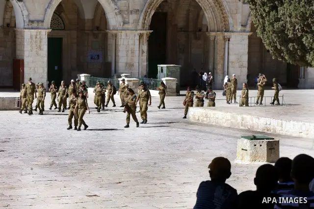 Israeli soldiers walk past the Al-Aqsa mosque compound, Islam's third holiest site, during a visit under Israeli police protection in Jerusalem's Old City on July 02, 2012. Photo by Mahfouz Abu Turk