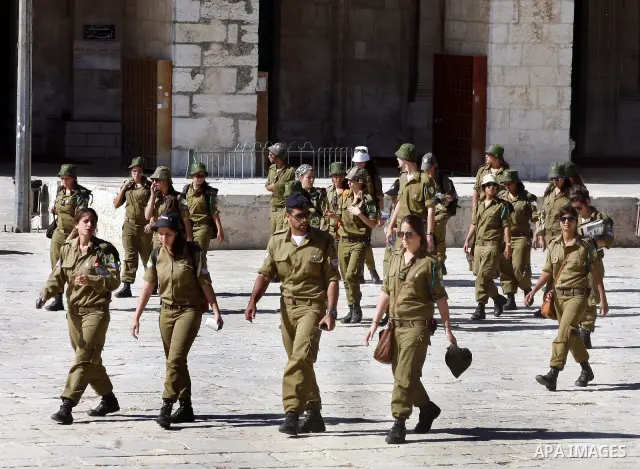 Israeli soldiers walk past the Al-Aqsa mosque compound, Islam's third holiest site, during a visit under Israeli police protection in Jerusalem's Old City on July 02, 2012. Photo by Mahfouz Abu Turk