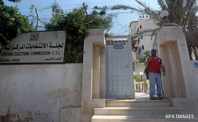 A Palestinian man stands near the Central Elections Commission (CEC) headquarters in Gaza city on July. 03,2012. Photo by Ashraf Amra