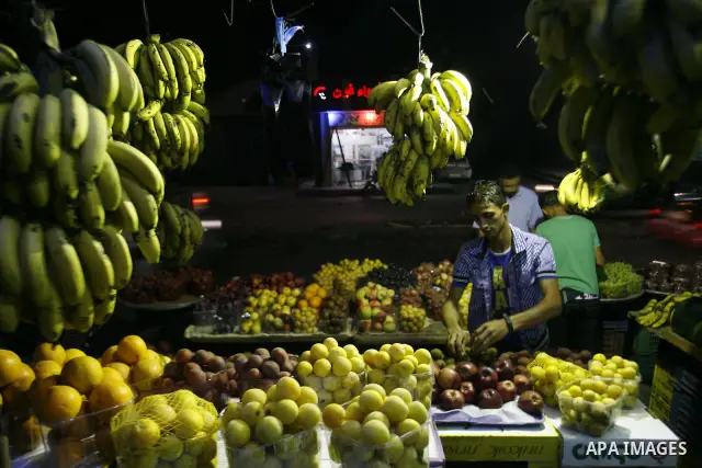 A Palestinian man sells fruits at a popular market in Rafah in southern Gaza on July 03, 2012. Photo by Eyad Al Baba