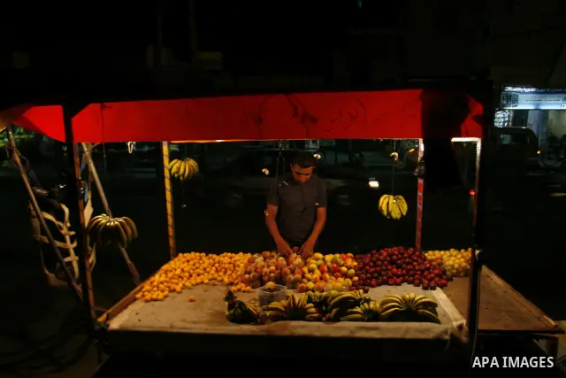 A Palestinian man sells fruits at a popular market in Rafah in southern Gaza on July 03, 2012. Photo by Eyad Al Baba