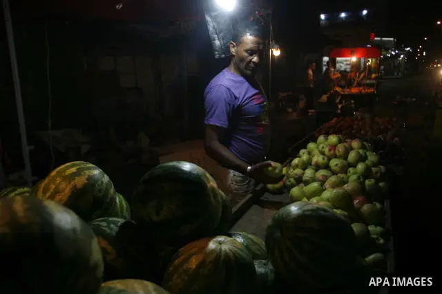 A Palestinian man sells fruits at a popular market in Rafah in southern Gaza on July 03, 2012. Photo by Eyad Al Baba