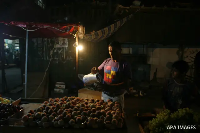 A Palestinian man sells fruits at a popular market in Rafah in southern Gaza on July 03, 2012. Photo by Eyad Al Baba