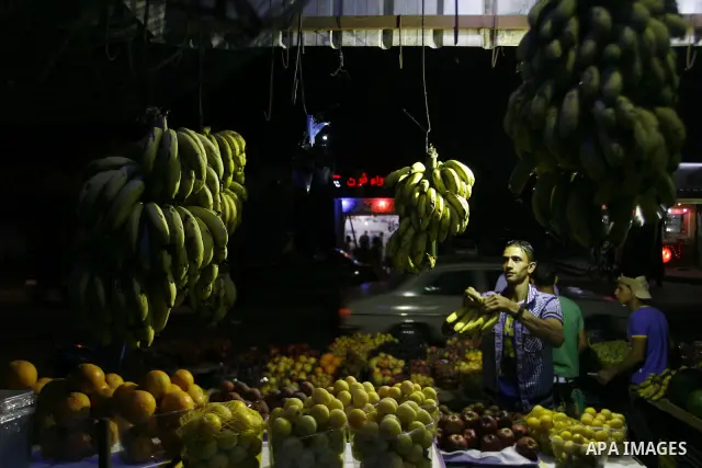 A Palestinian man sells fruits at a popular market in Rafah in southern Gaza on July 03, 2012. Photo by Eyad Al Baba