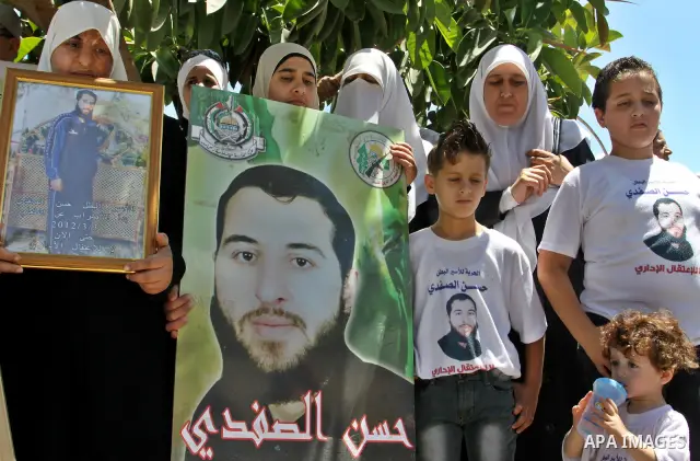 Palestinians gather during a protest in front of the Red Cross' offices in West Bank city of Nablus calling of release of palestinian prisoners on July, 04, 2012. Photo by Nedal Eshtayah