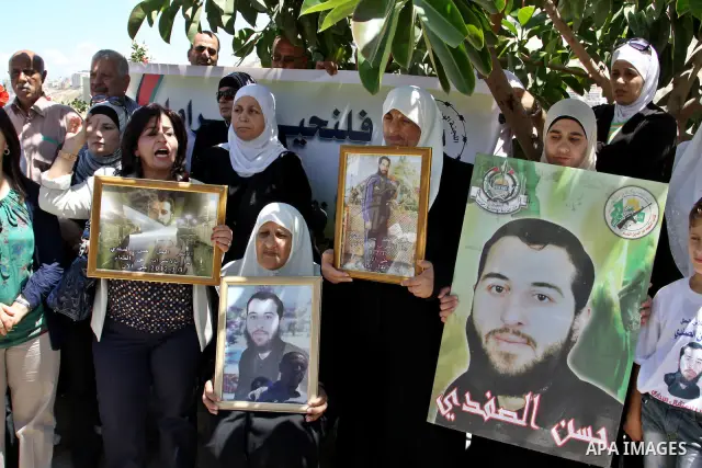 Palestinians gather during a protest in front of the Red Cross' offices in West Bank city of Nablus calling of release of palestinian prisoners on July, 04, 2012. Photo by Nedal Eshtayah